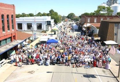 Crowd of people, aerial, in Maroa, IL town center